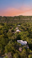 From above, you can see just how unique this property is—perched among the trees with views of the rolling Hill Country. This home blends seclusion with convenience, offering a true “treehouse” lifestyle while keeping you close to Austin’s best schools, lake access, and community amenities.