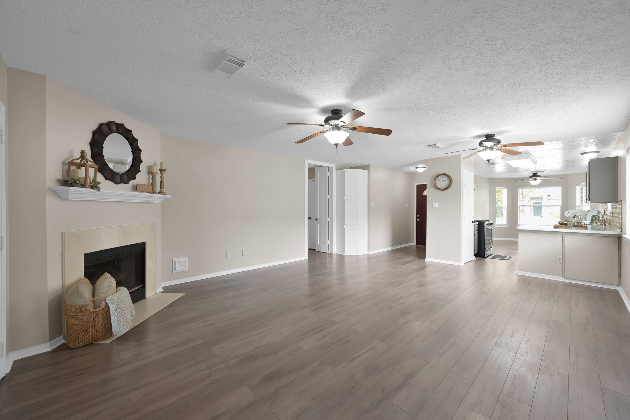 All main living areas and bedrooms have been updated with PREMIUM LAMINATE WOOD MOISTURE-RESISTANT FLOORING. Note the two (2) CEILING FANS.