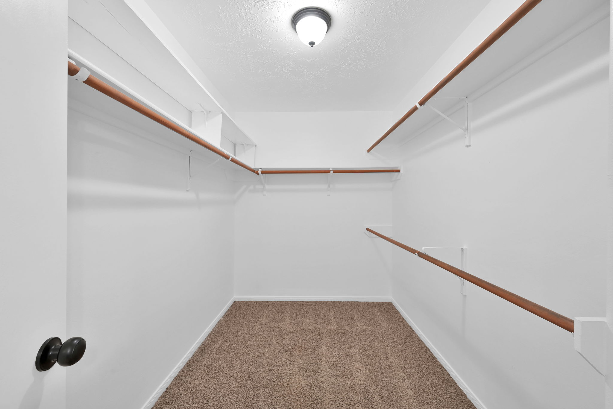 PRIMARY BEDROOM CLOSET - Although not reflected in the photo, this walk-in closet has MULTILEVEL BUILT-IN SHELVING (both sides of the door).