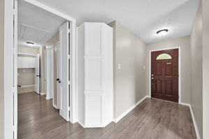 Looking back towards the front door. The hallway on the left leads to the 3 bedrooms & Utility room. (Note the built-in STORAGE CABINETS in the corner.)