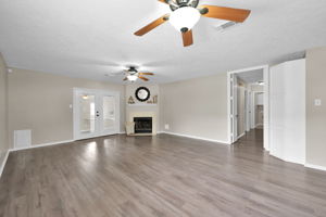 You'll appreciate having a WOOD BURNING FIREPLACE (w/ gas logs) in those colder months of the year, and if you have pets, the "Doggie Door" that is seen in the far left corner of the photo.