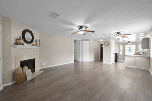 All main living areas and bedrooms have been updated with PREMIUM LAMINATE WOOD MOISTURE-RESISTANT FLOORING. Note the two (2) CEILING FANS.