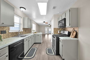 Notice how "nice & bright" this kitchen is!! - - Walls & cabinets have been freshly painted, with new hardware added (June 2024).