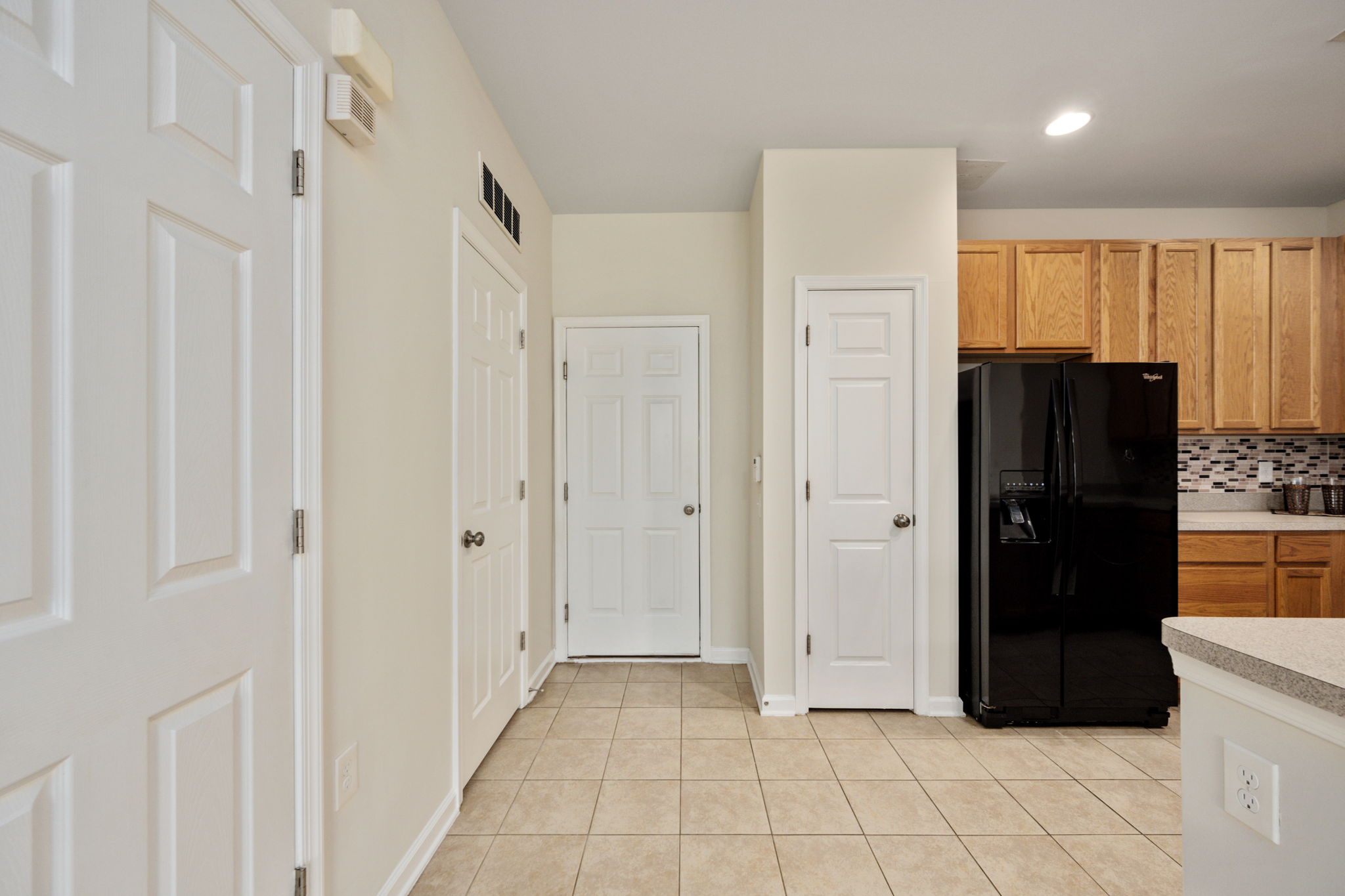 Kitchen pantry and door to garage