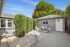 AI-generated. Patio roof removed and tall hedges added.