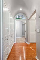 Gorgeous custom built-in closets with barrel ceiling and stained glass window
