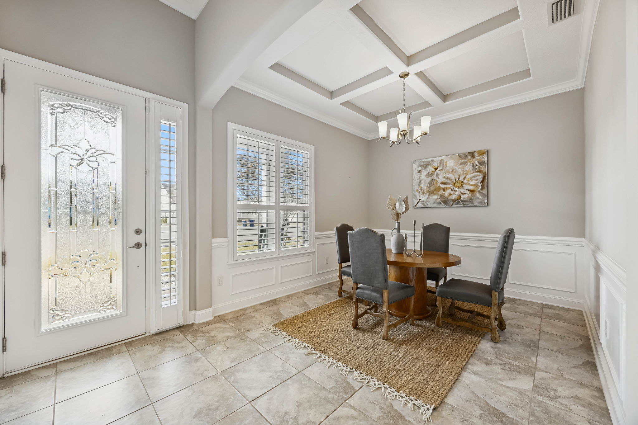Framed by a coffered ceiling, crown molding, and elegant wainscoting ...