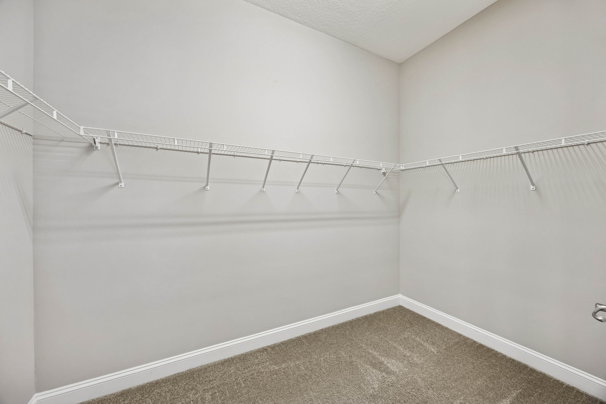 Well-planned, the primary closet offers generous storage to support two full wardrobes ...