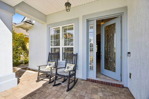 A covered front porch creates a warm and inviting arrival ...