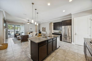 ... granite countertops extend across the island and perimeter, offering generous prep space and timeless durability