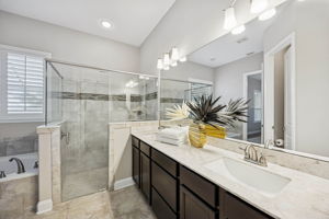 An extended dual-sink vanity and ample cabinetry ...