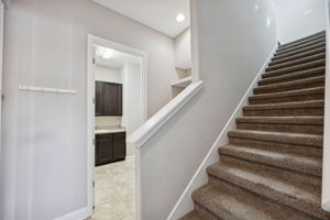 Positioned just off the garage and across from the laundry ...