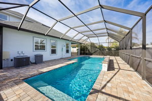 The 15,000-gallon pool includes a sun shelf for lounging and a depth range from 3 to 6.5 feet