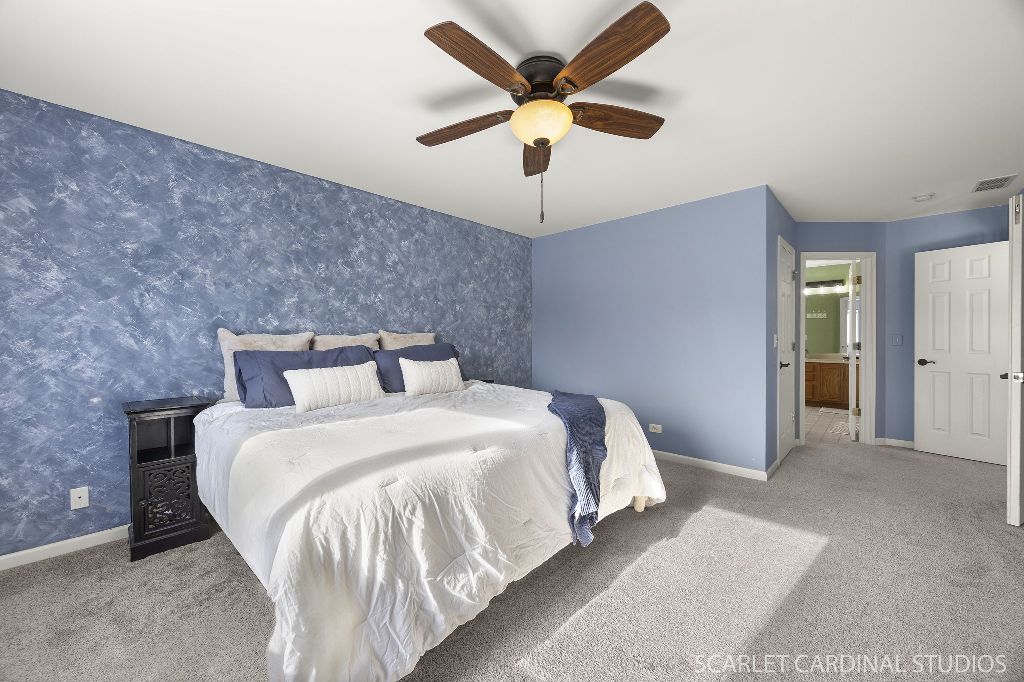 Primary bedroom with custom walk-in closet & private spa-bath