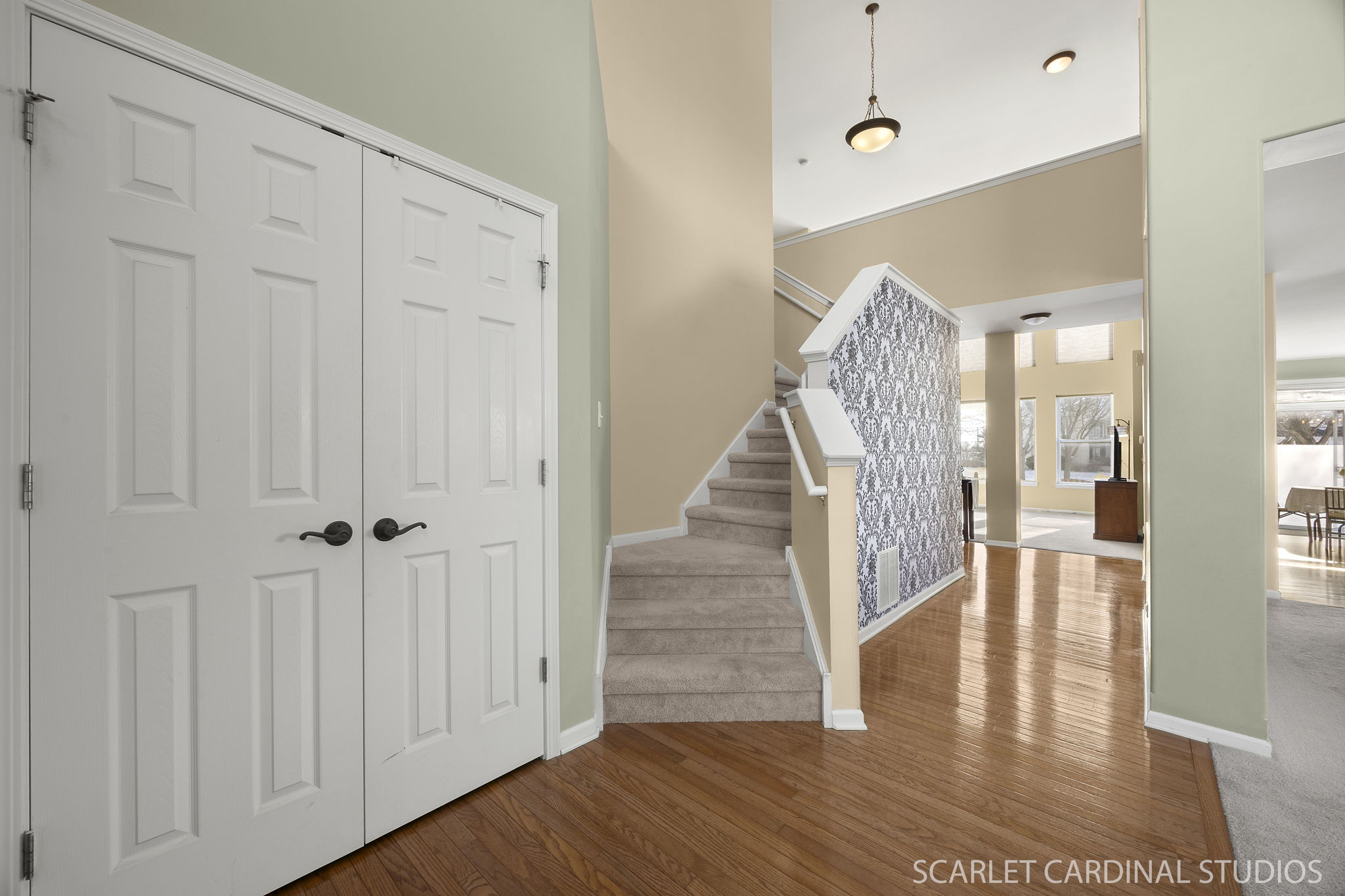 Dual staircase, gleaming hardwood floors & 2 story living room greet you upon entering...