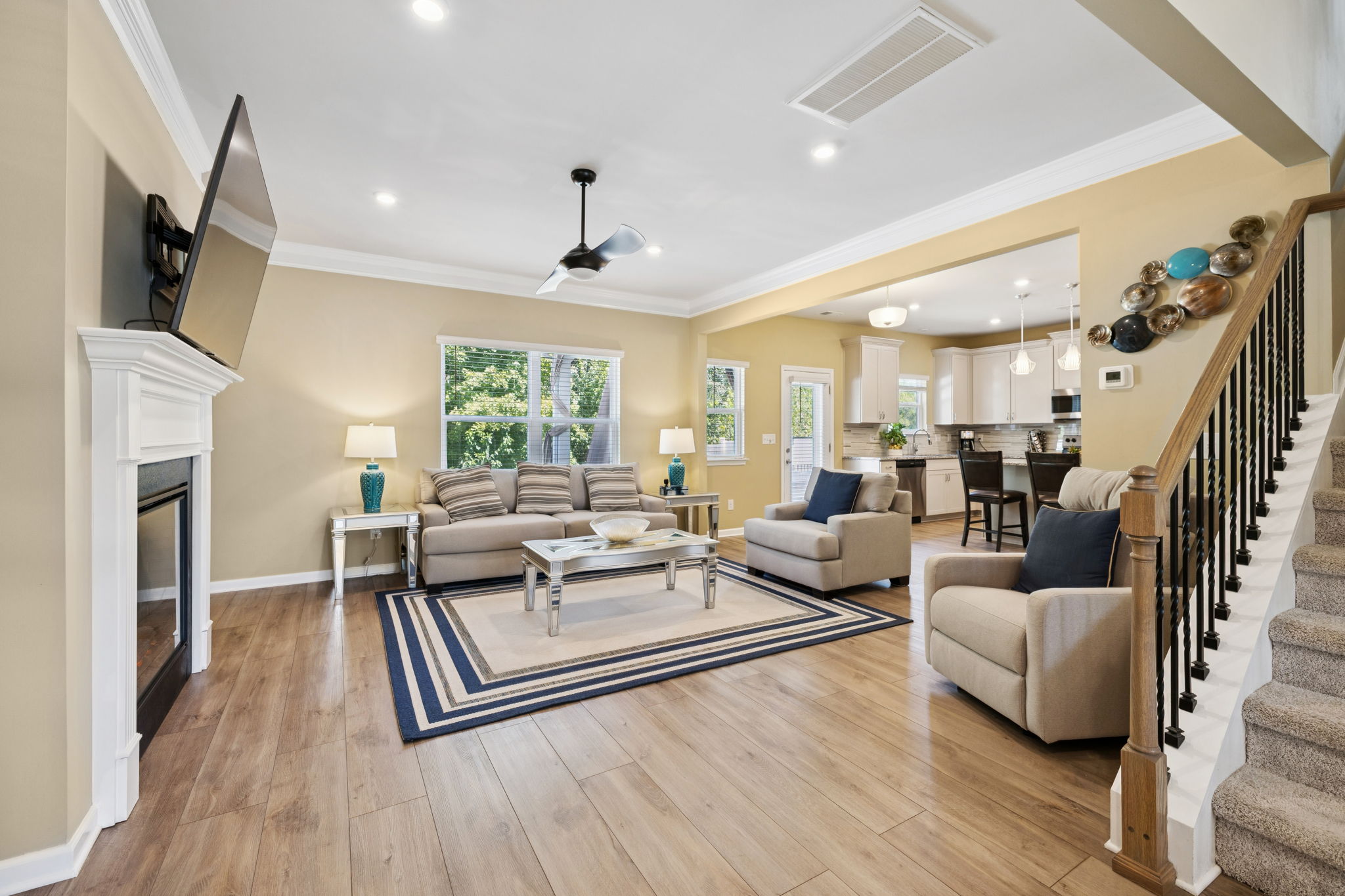 Open concept plan. Living Room flows between kitchen and dining room.   All mounted TVs and TV mounts to remain.