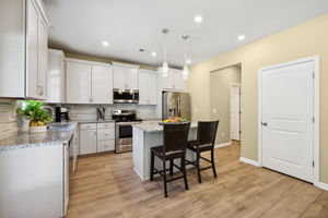 Island Kitchen with granite and brushed nickel hardware package.