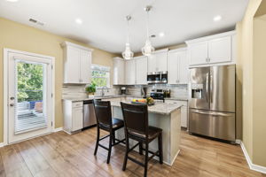 Upgraded lighting in Kitchen - both flush-mounted and pendant lighting over island.