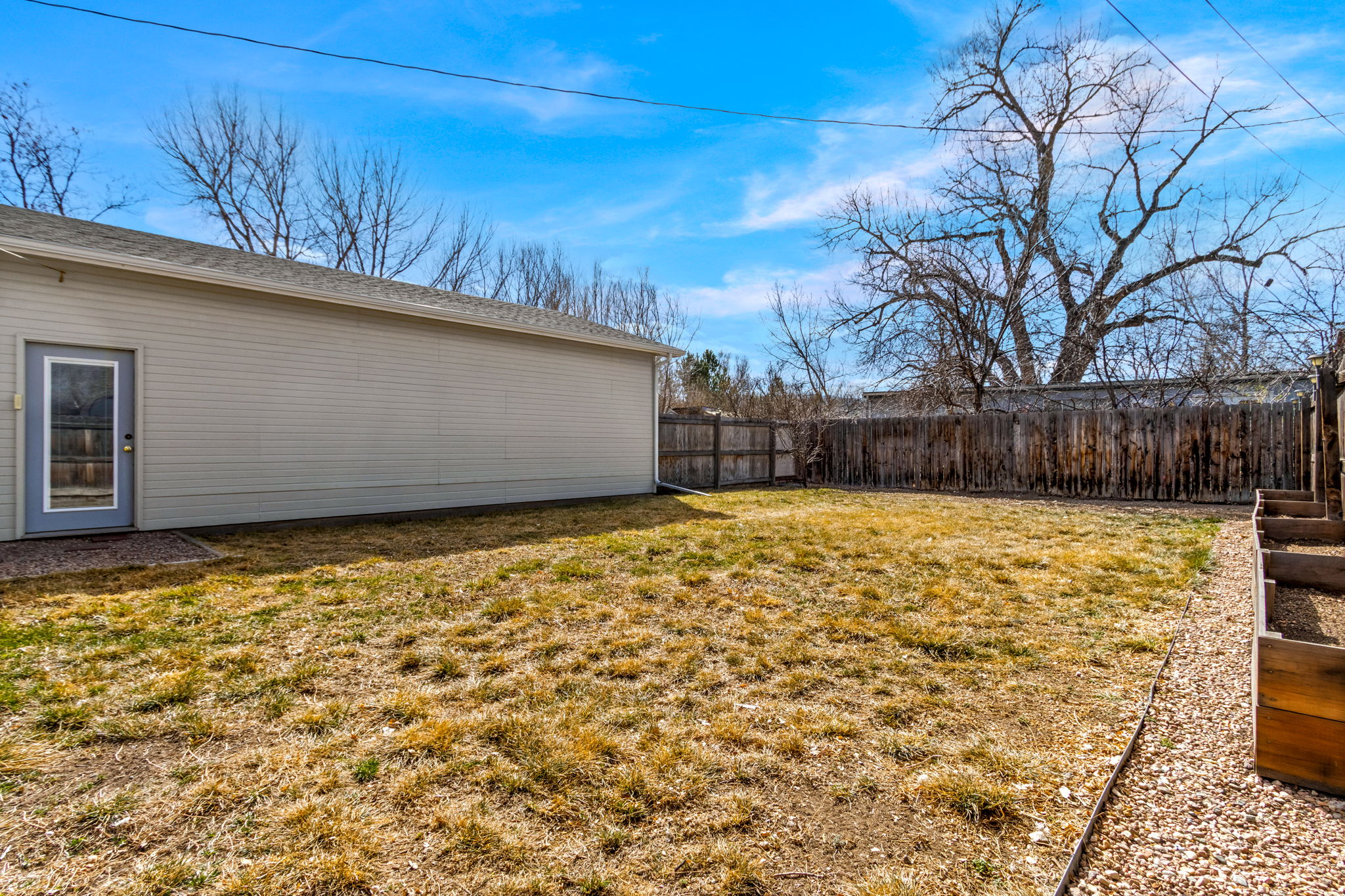 This backyard really delivers! Raised redwood garden boxes, plenty of space for running, playing, animals, and even chickens, if you'd like!
