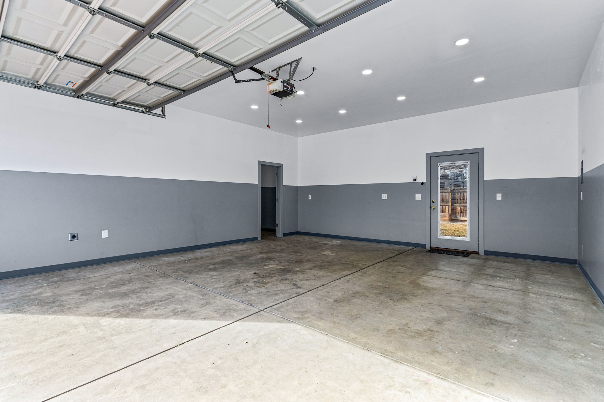 Door on the left leads to the single bay and door on the right connects to the fully fenced backyard.