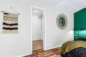 Walk-in closet in primary bedroom suite
