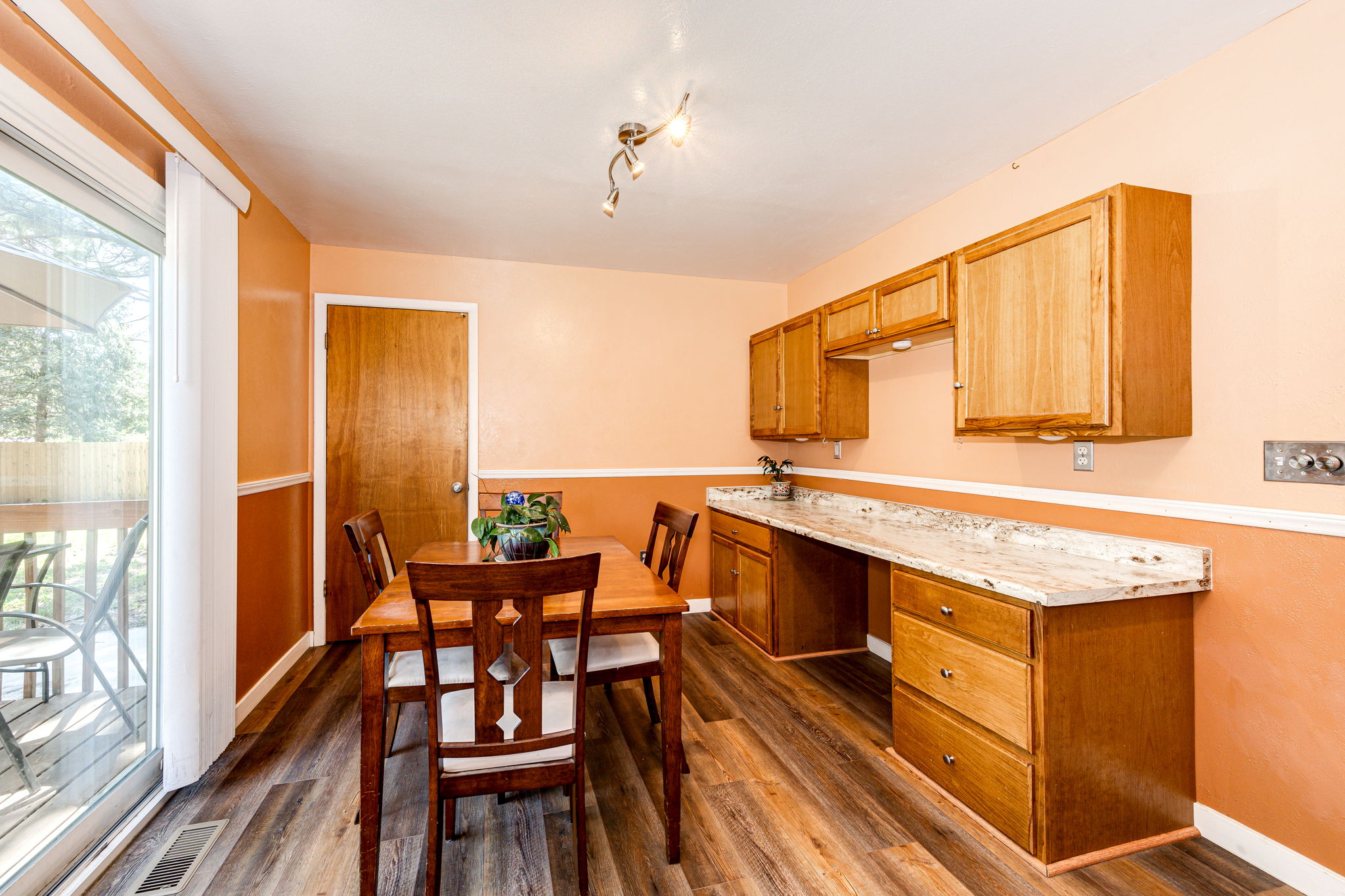 Kitchen has a Eat-in space and a secretary desk! View of the door leading out to the garage and down into the basement