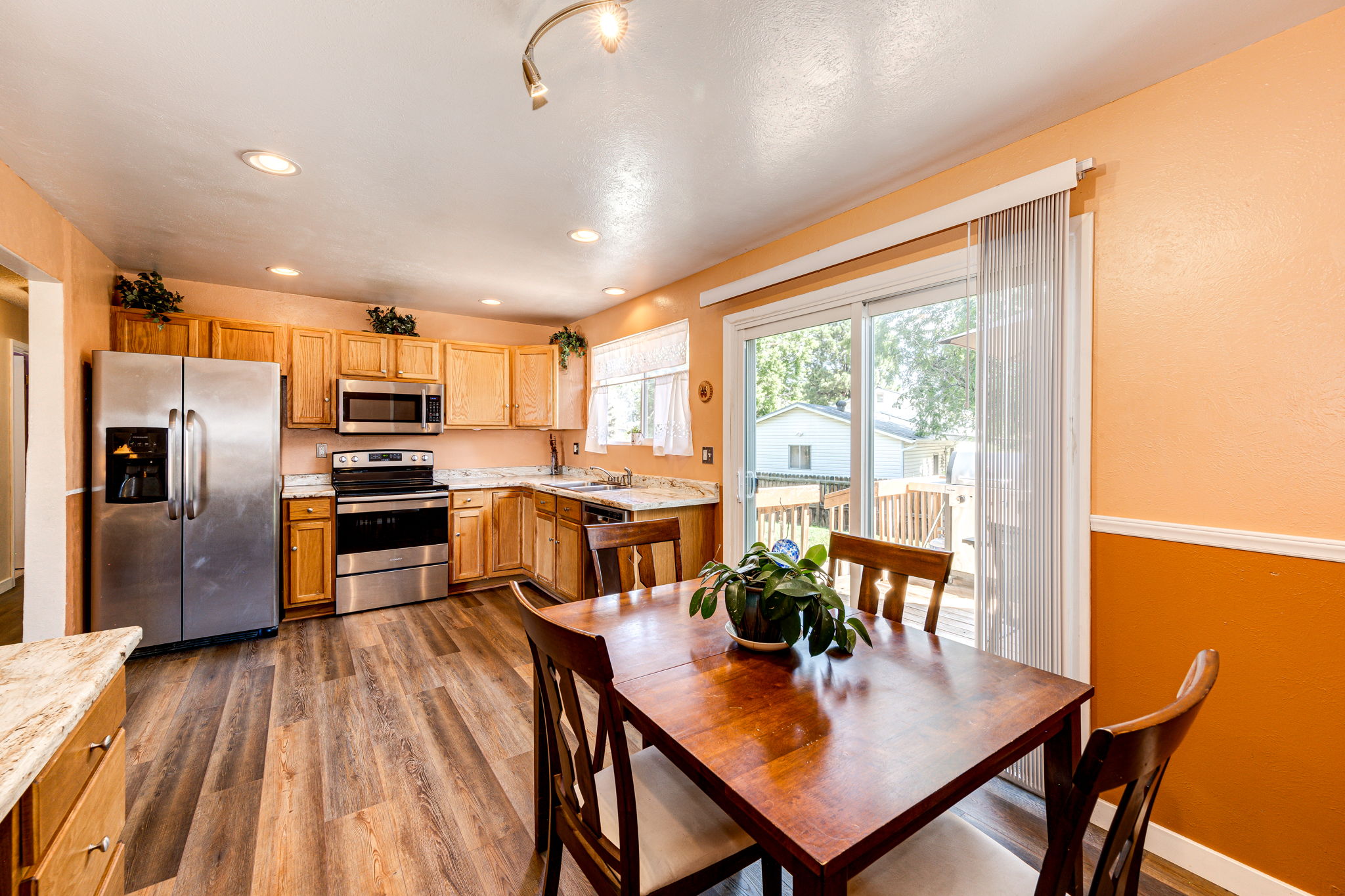 Eat-in space off of the kitchen with patio doors leading out onto the backyard deck area