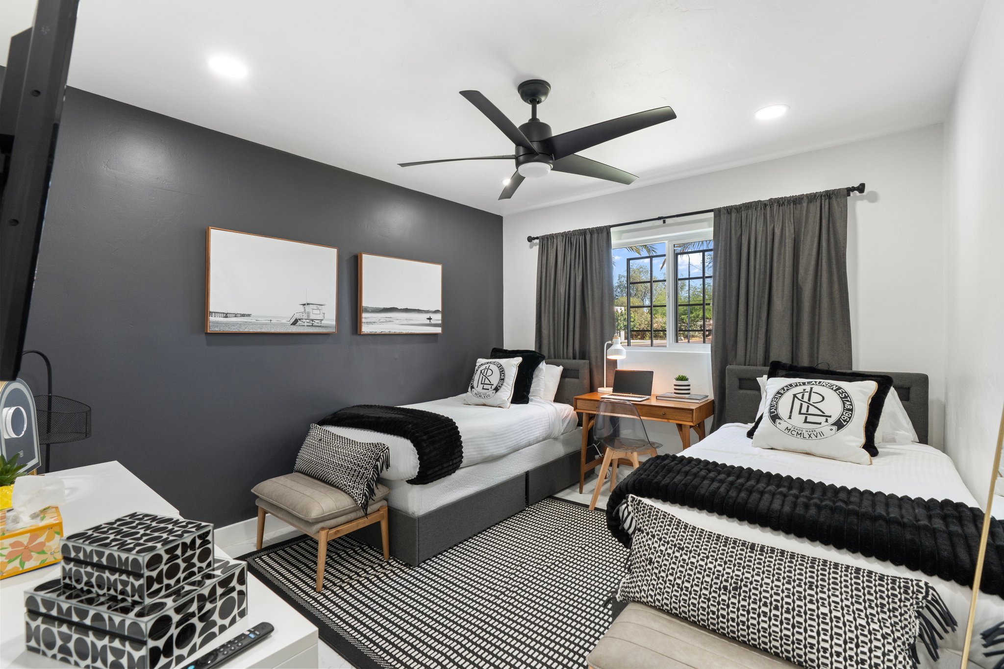 Third Bedroom. Two single beds in charcoal and crisp white, with a desk.
