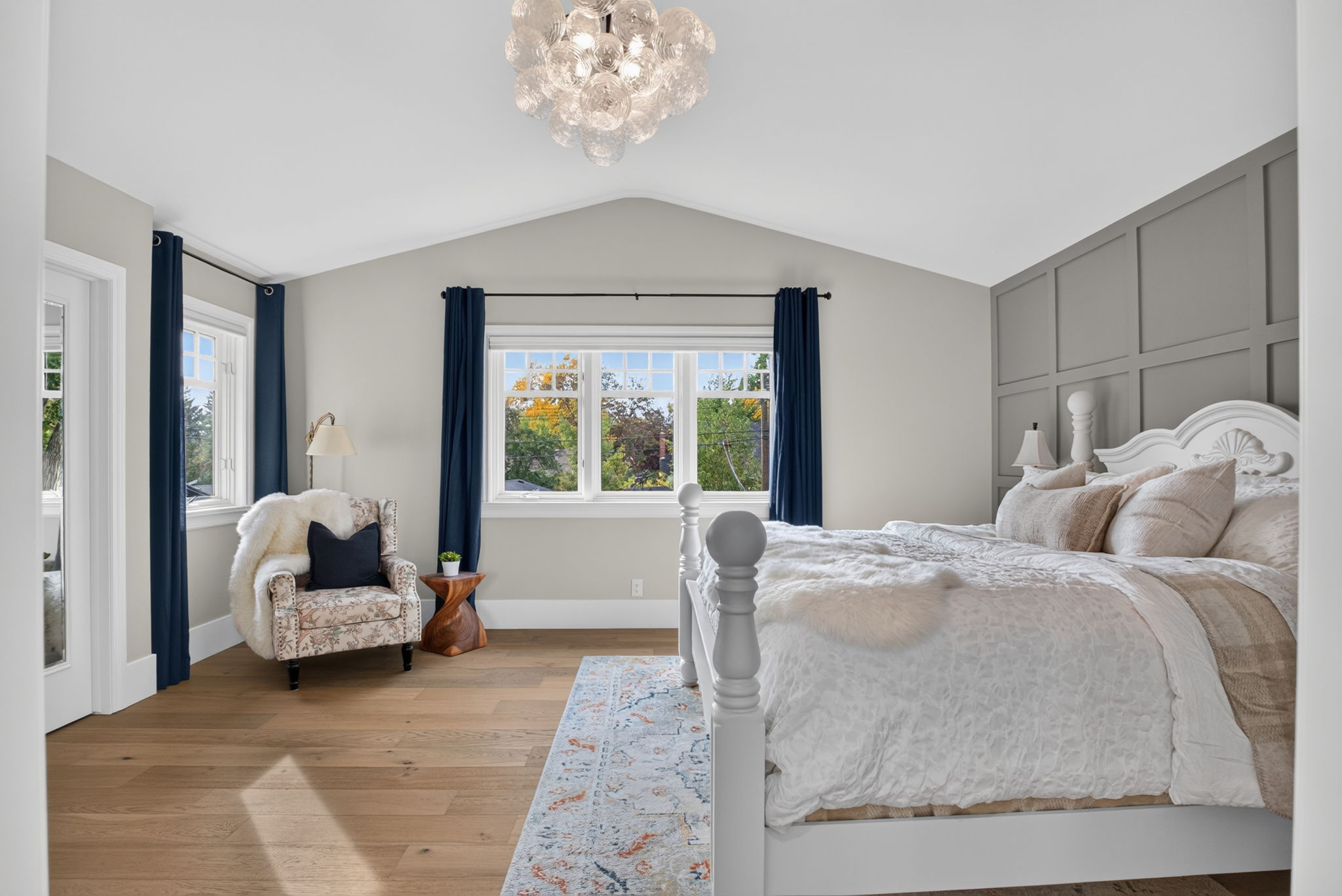 Vaulted primary retreat with panelled feature wall