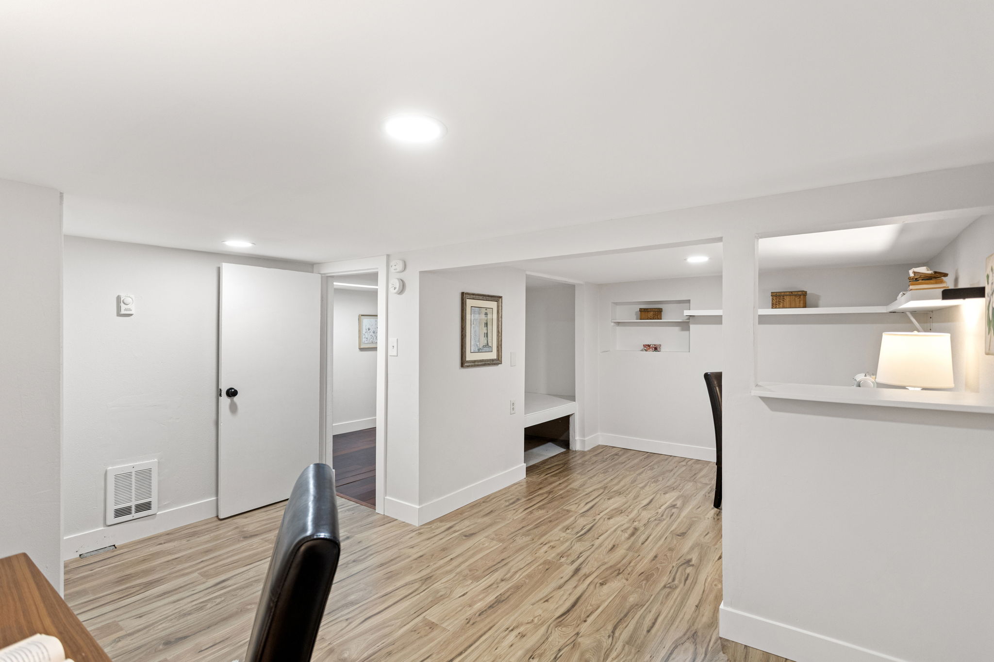 The bonus room opens to the daylight corridor beyond — wall heater on board for the zones the mini-split doesn't reach.