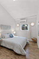 The skylight seals it — vaulted ceiling, natural light from above and through the south-facing window. This bedroom lives above its grade.