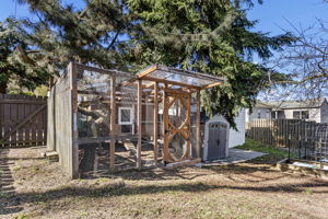 Gate, canoe, compost tumbler — the far end of a fully fenced 5,100 sq ft corner lot.