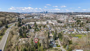 Seattle skyline ahead, Hwy 99 and 509 right there — 18 minutes to downtown. What the drone can't show: Good Voyage, Honor Mexicano, Loretta's, South Town Pie, and Little Jaye all within walking distance on 14th Ave S. South Park is the real thing.