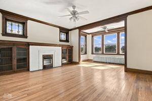 Third floor living room,  vintage stain glass windows, deco fireplace and adjacent built-ins