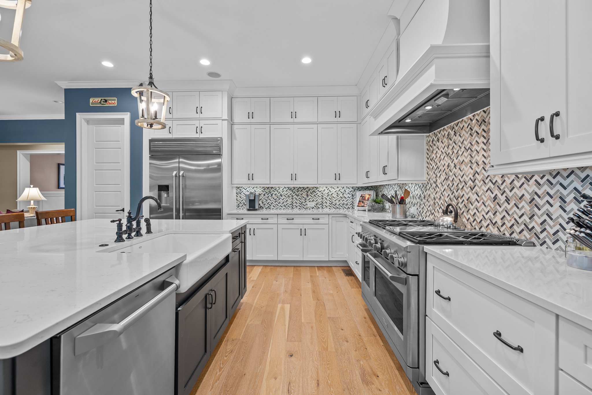 The Island houses the Wine Refrigerator, Dishwasher, and Microwave.