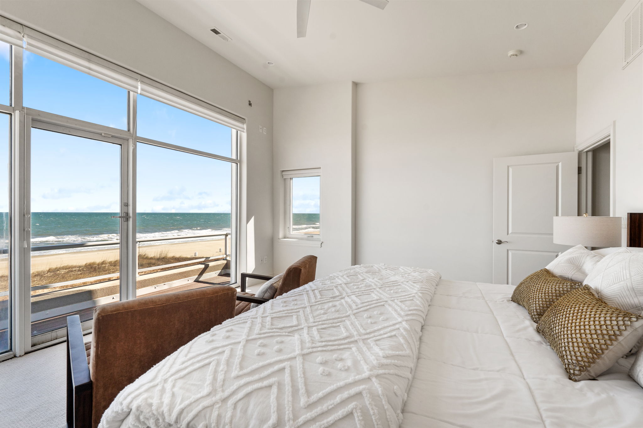 Primary bedroom offers sweeping vistas of the ocean