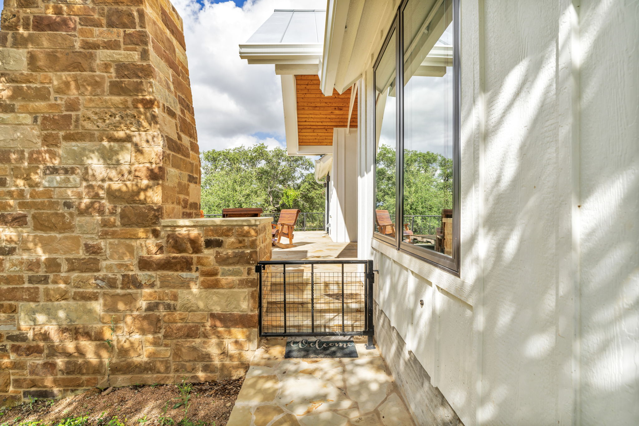 Side entry and gate to patio and outdoor fireplace