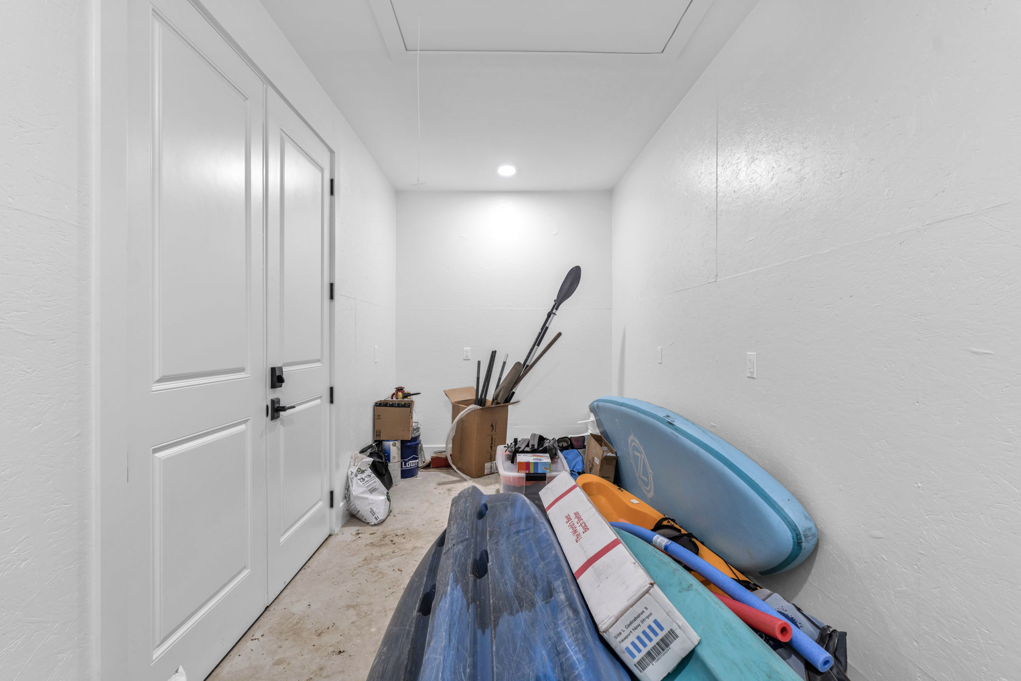 Storage closet across back of carport large enough for paddle boards, canoe, kayak, and much more!