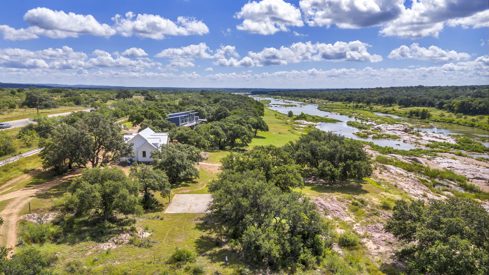 Aerial view of acreage and the home