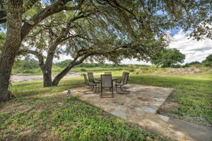 River side relaxation on the shady Flagstone patio under the oak trees with fire pit