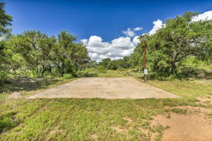 Pad ready for a motor home or pickle ball court or additional picnic area has electric outlet and ready for additional fun or place to camp