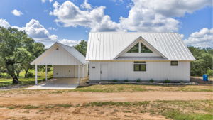 Attached covered parking in this two-car carport with  large storage closet