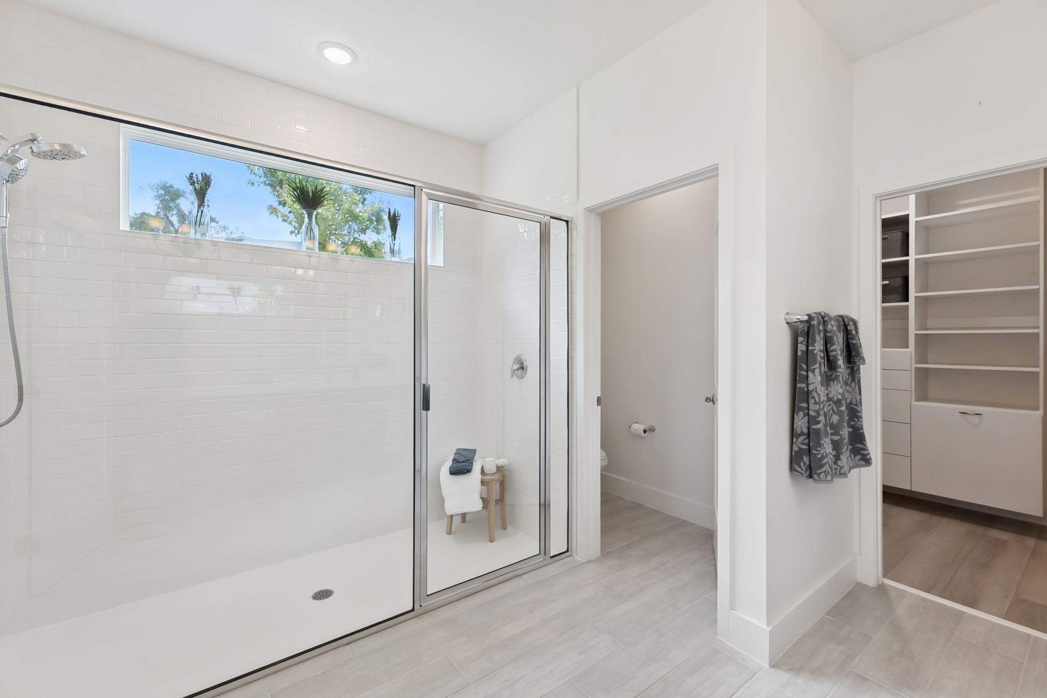 Primary Bathroom with Oversized Shower and Walk-in Closet with Custom Closet Design