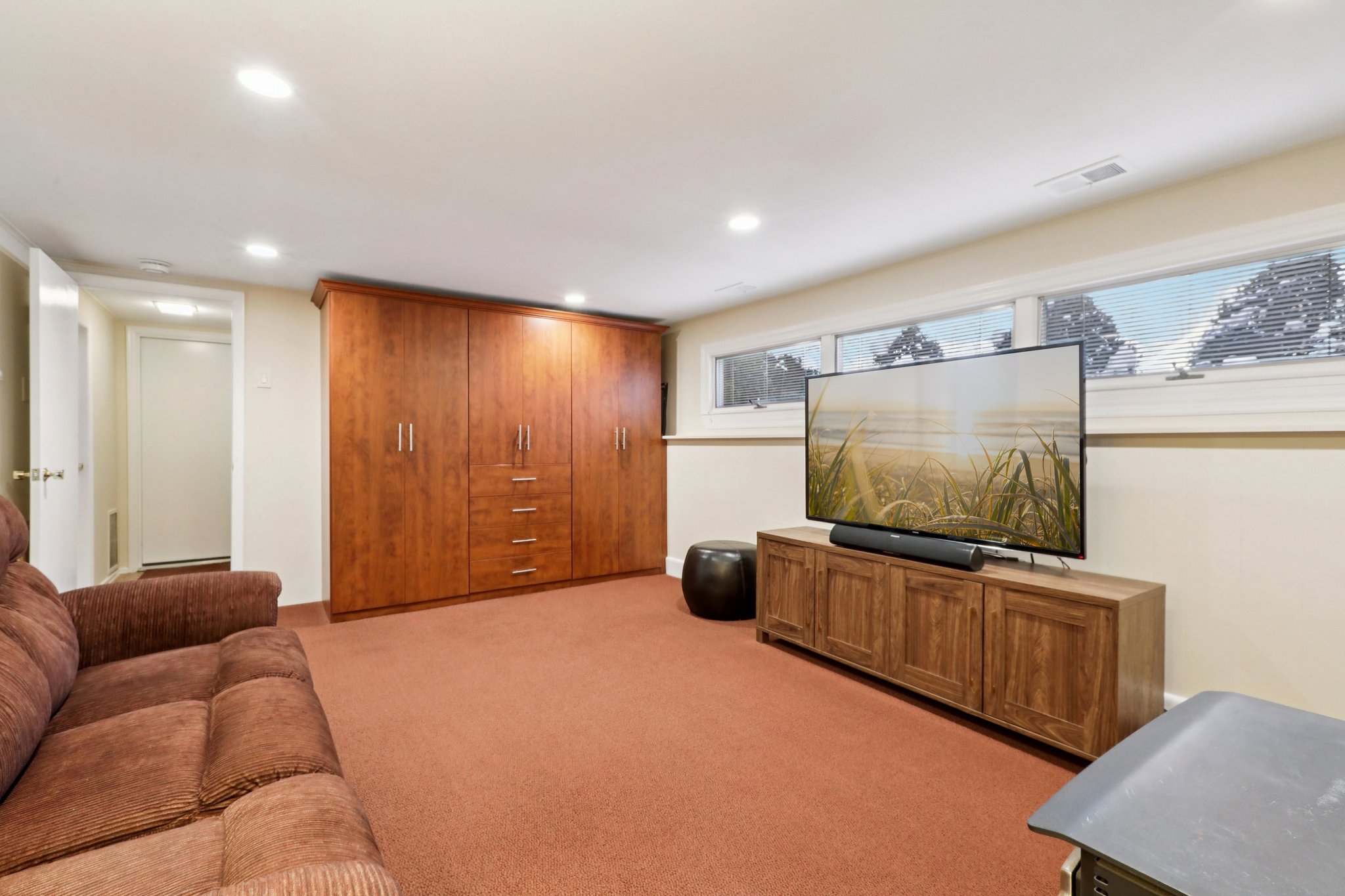 View of the Family Room, California Closet built-in is included offering loads of easy accessible storage. Door to garage, laundry room, large closet and stairs to the main level. Also there is the 4th BR with en-suite bath, currently used as an office/gym.