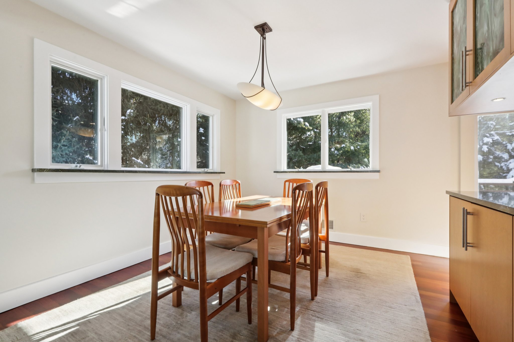 A verdant setting in this picture for the Dining Area with private views to the side and rear yards.