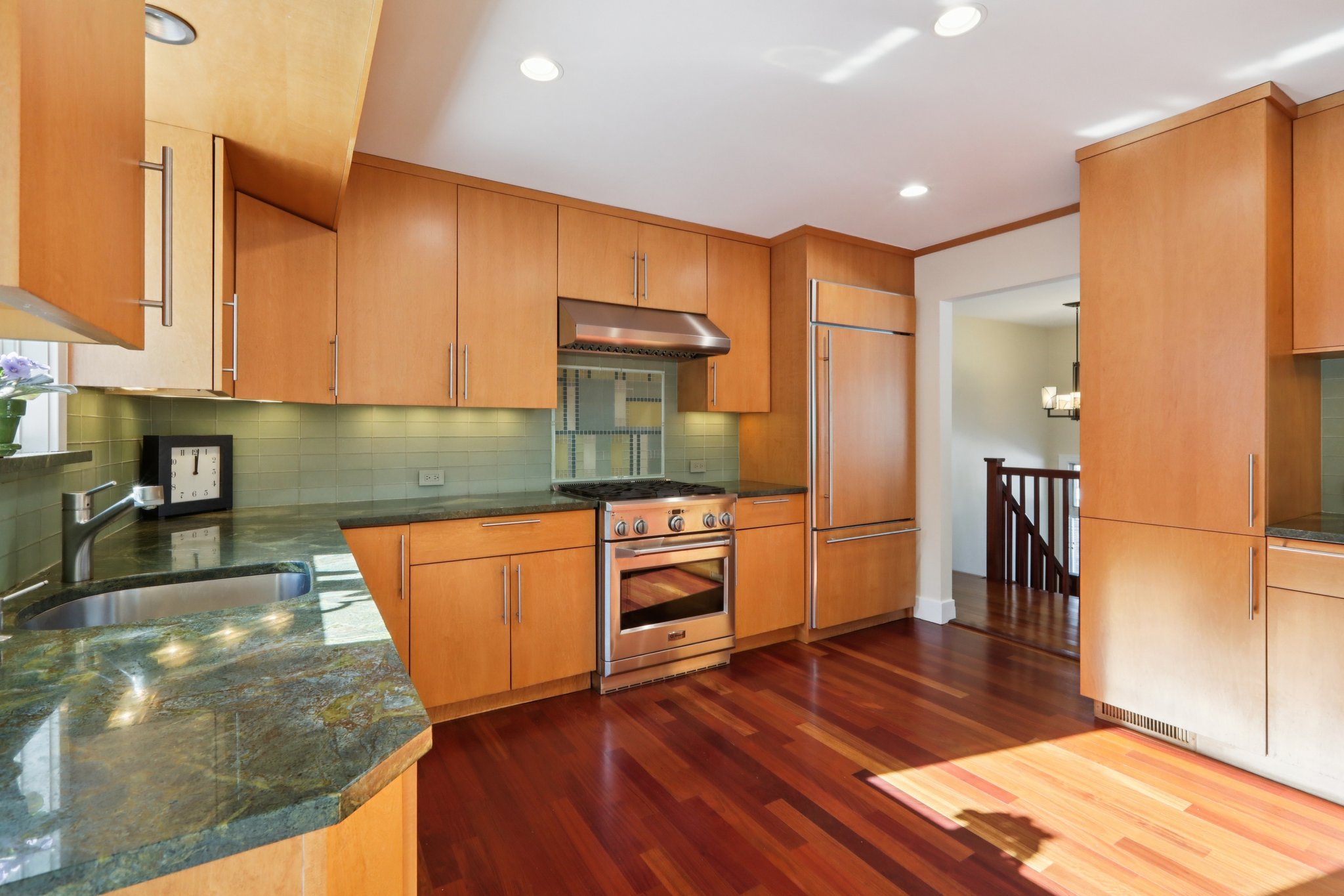 Notice the appliances - new gas stove top vented to the ext, electric oven below; custom door front refrigerator, pantry with custom shelves & pullouts.