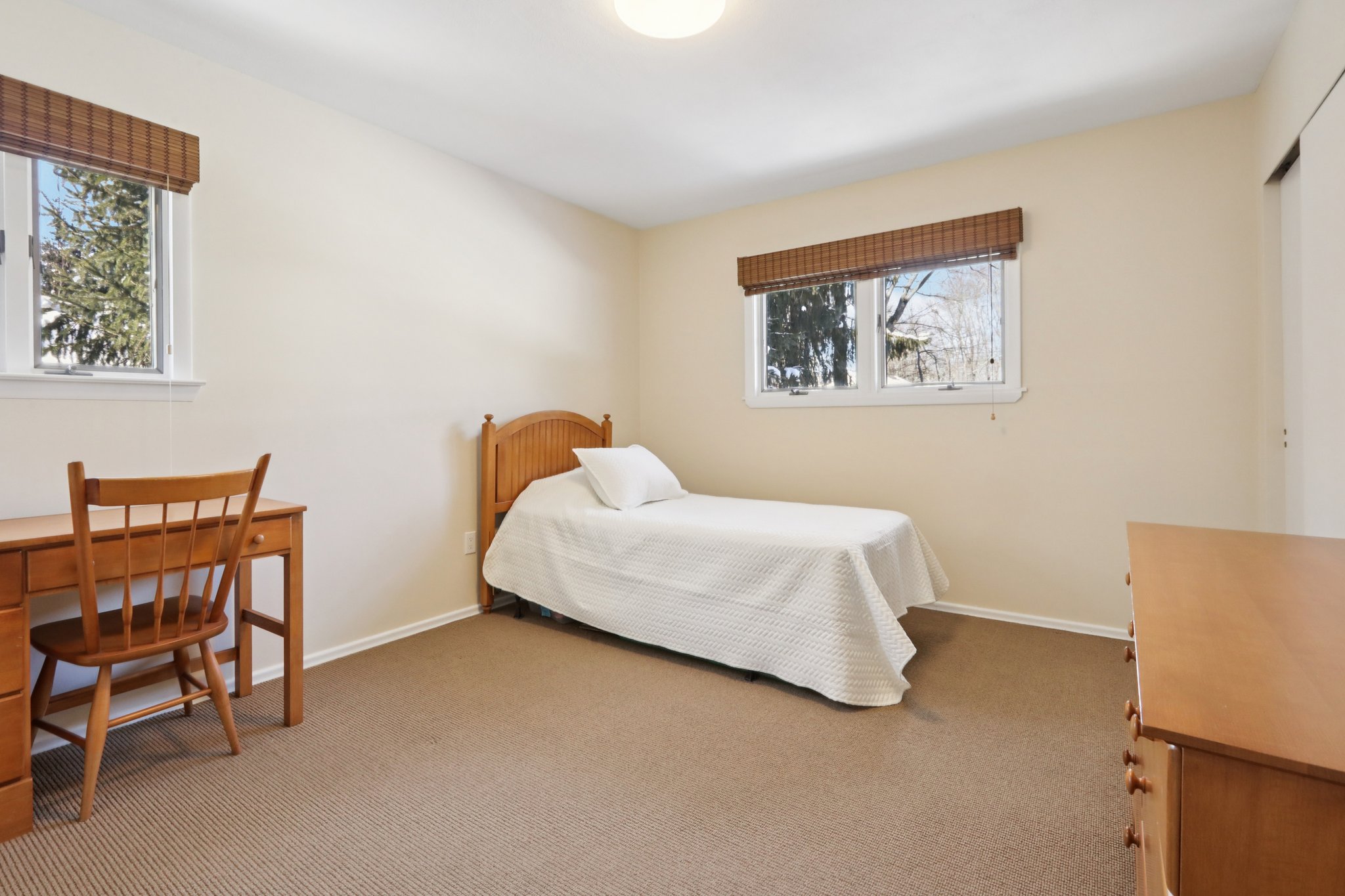 Corner Bedroom with two windows, double closet, carpeted.