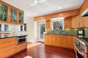 A view as you enter the kitchen from the hall, new wood floors, granite counters, glass tile backsplash, new french door to deck, new window, all new appliances & custom cabinetry.