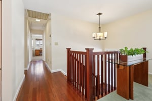 Gleaming wood floors in this entry with a view to the hallway to the bedroom area.