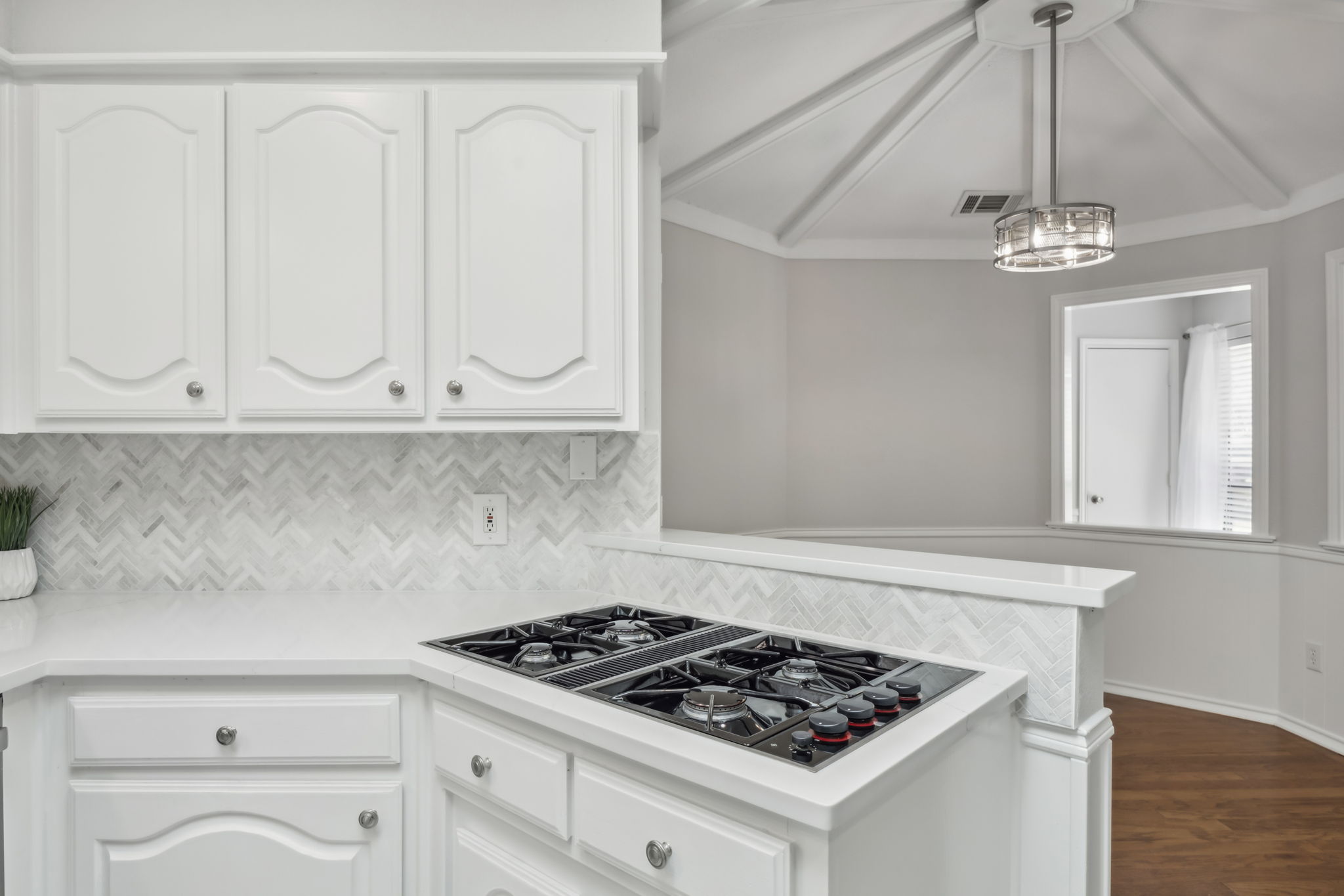 Here is another view of the stylish Backsplash and the AMAZING JennAir Gas Cooktop!  You can also catch a glimpse of the Breakfast room!